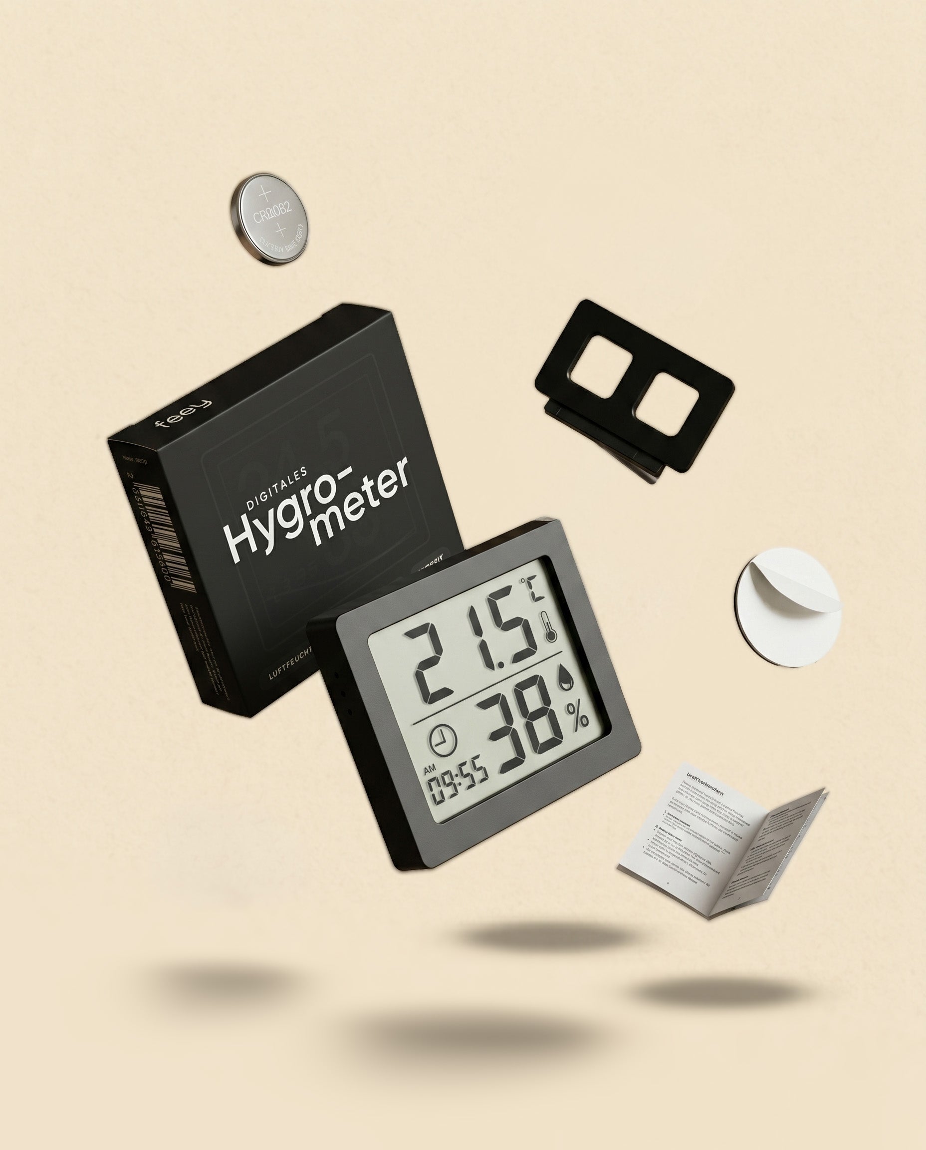 Das Hygrometer auf hellem Hintergrund zeigt 21,5 °C und 38 % Luftfeuchtigkeit an - ideal für Zimmerpflanzen. Wird mit einem Verpackungskarton, Montagezubehör und einer offenen Bedienungsanleitung geliefert.