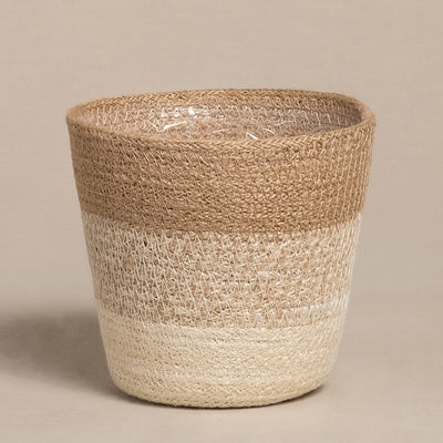 Der Pflanzenkorb aus Jute (Lapis | 14 cm Ø) ist ein handgefertigter Korb mit einer breiten, runden Öffnung und einem erdigen Farbmuster aus horizontalen Bändern in Hellbraun, Beige und Creme auf neutralem Hintergrund – ideal für Ihre Lieblingszimmerpflanze.